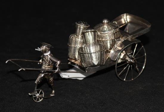 A sterling silver cruet set modelled as a rickshaw.